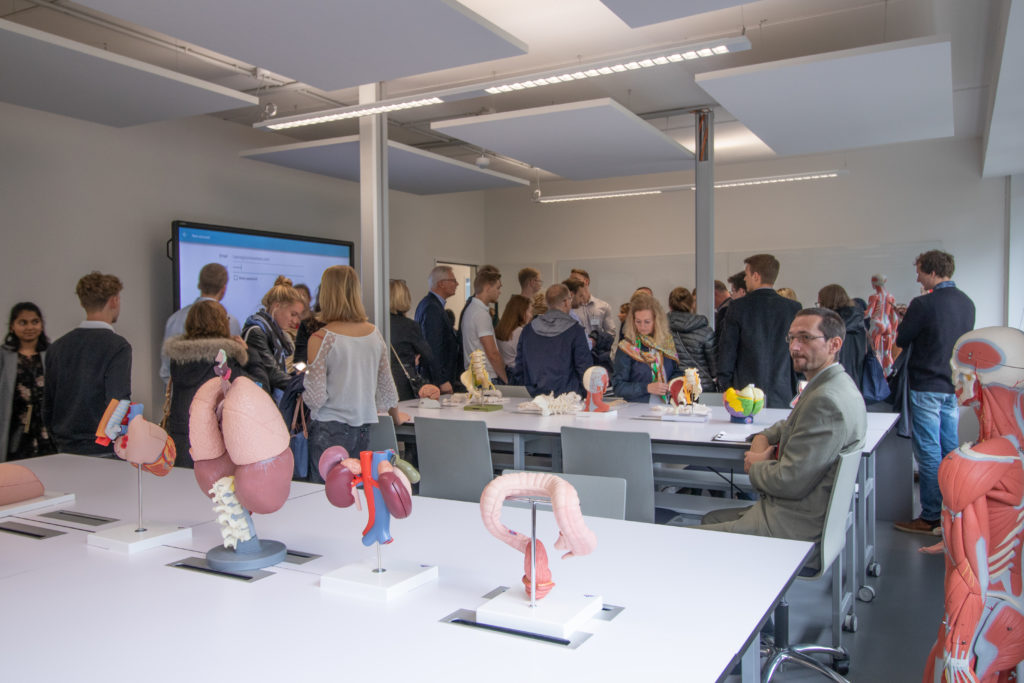 Visitors gathering in classroom with anatomy models at UMCH